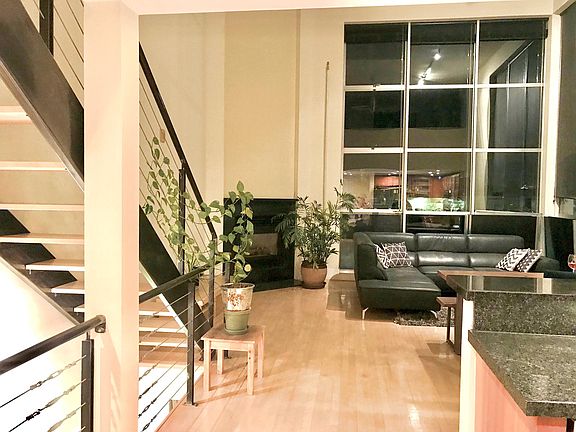 Main floor living room with kitchen to the right