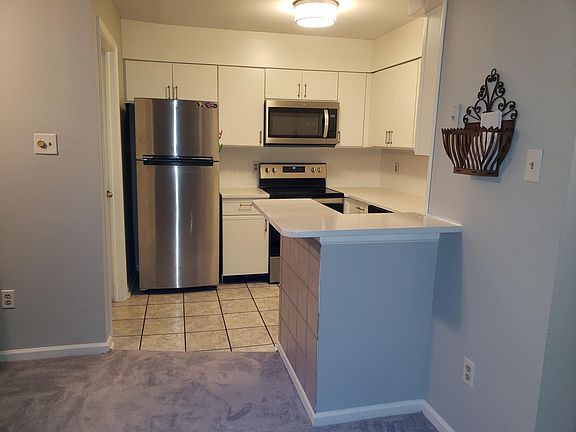 Kitchen has quartz counter tops and stainless steel appliances.