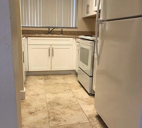 Kitchen view from dinning room (New refrigerator, Stove, Microwave, Dishwasher and garbage disposal.