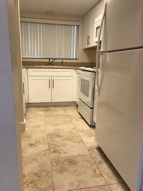 Kitchen view from dinning room (New refrigerator, Stove, Microwave, Dishwasher and garbage disposal.