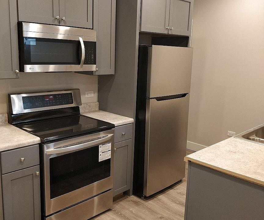Kitchen with smooth top electric range.