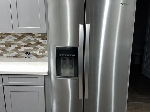 New Whirlpool side by side stainless steel refrigerator.