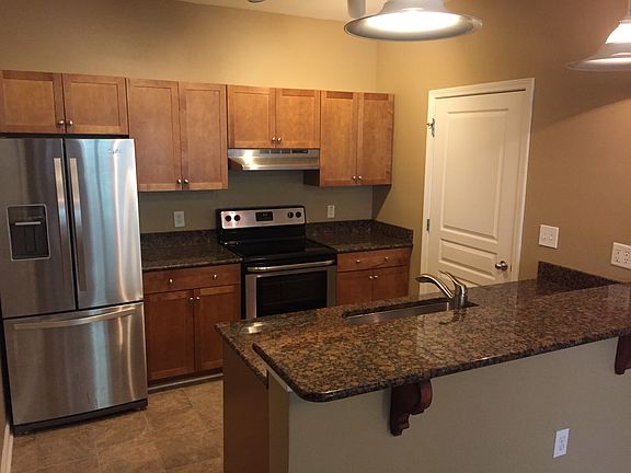 Kitchen with granite and stainless steel appliances/refrigerator and new lighting