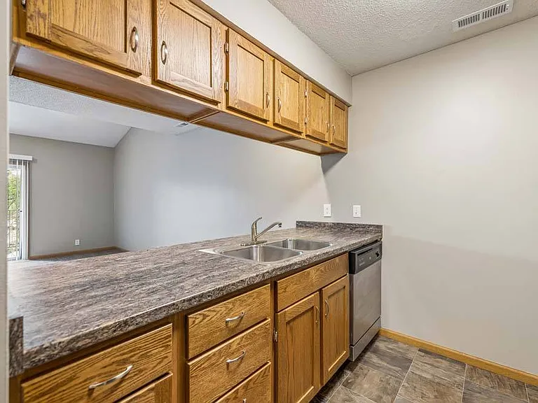 A well-appointed kitchen with ample cabinetry and a breakfast bar makes everyday meals and casual gatherings feel effortless.
