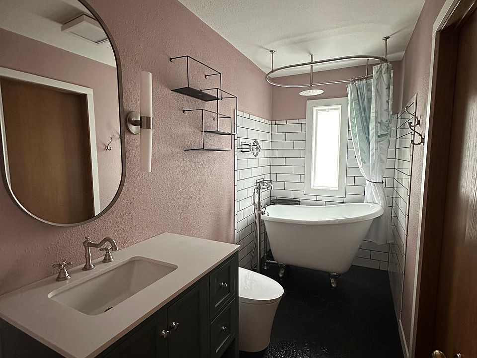 Upgraded Upstairs Bathroom, stout clawfoot tub for deep soaking, door access from bedroom and hallway.