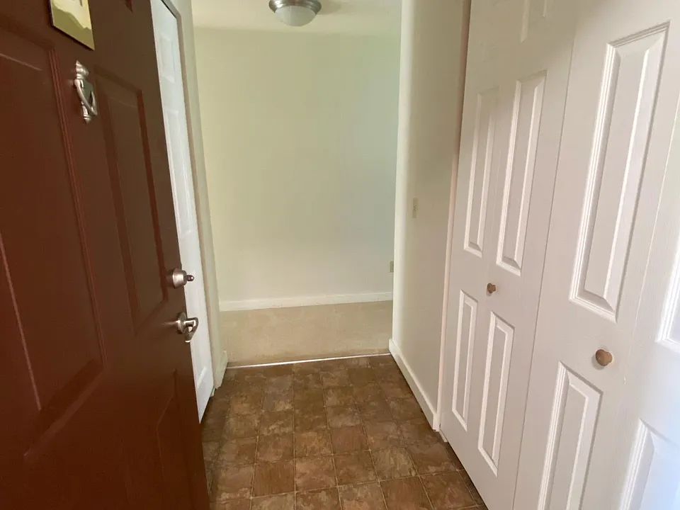 Foyer with coat closet on the right and laundry closet on the left. Full size washer and dryer included.