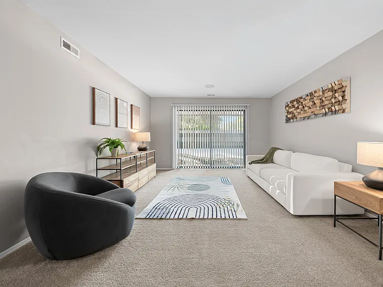 Spacious Living Room with Sliding Glass Door at Lakeside Village Apartments Clinton Township MI