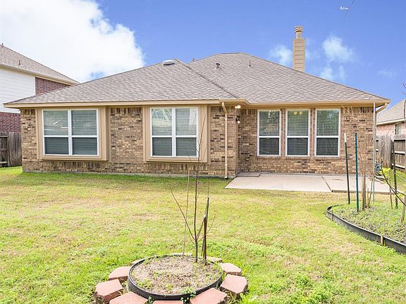 Back of house. Low maintenance brick, with extended patio.