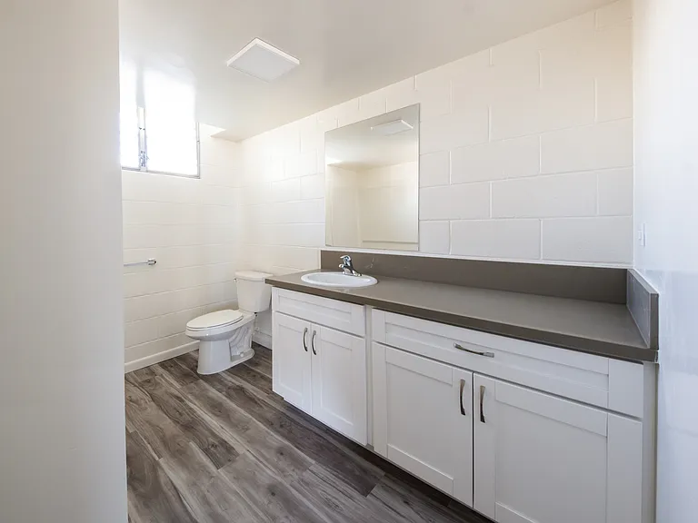 Modern bathroom with a spacious vanity and a generous mirror for added style.