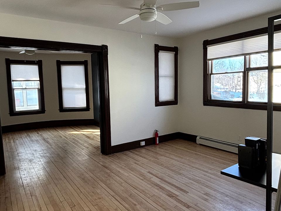 Spacious living or dining room with hardwood floors, large windows, and abundant natural light. Flexible layout to suit your lifestyle.