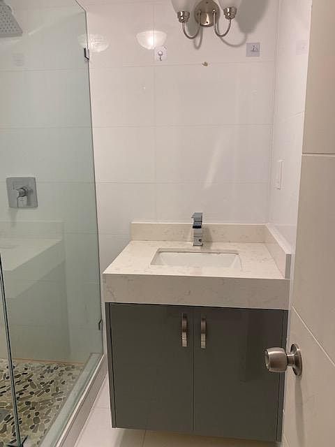 modern custom made vanity with quartz top.