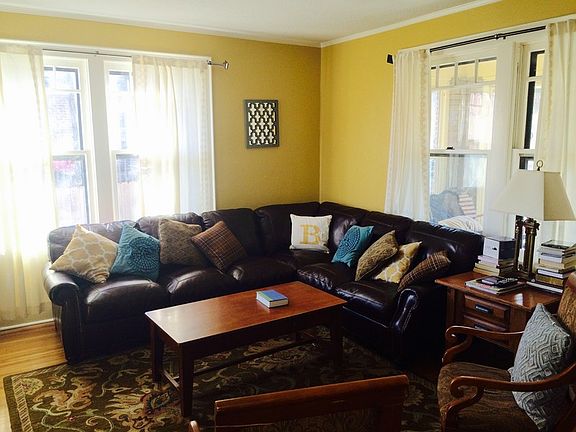 Living Room
						:
						Bright, sunny living room with lots of windows and fireplace with original tile