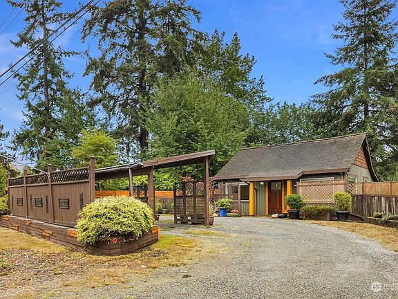 Loads of space for parking! A single car carport plus a drive-thru driveway. >