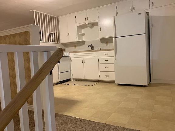 Spacious open kitchen; windows (not visible) to the right with space for bistro-type table
