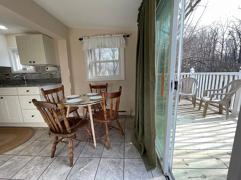 Sliding glass door to wrap around deck. Come enjoy the peaceful view of the woods from here.