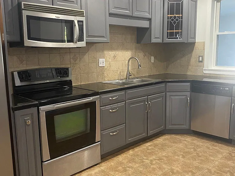 Updated kitchen with micorwave, over, dishwasher, and fridge.