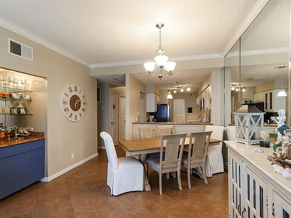 Dining/wetbar/kitchen area. Enjoy a nice glass of wine on the balcony after a long week.