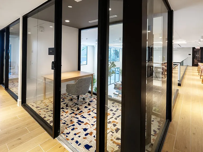 Upper-level resident lounge with work pods