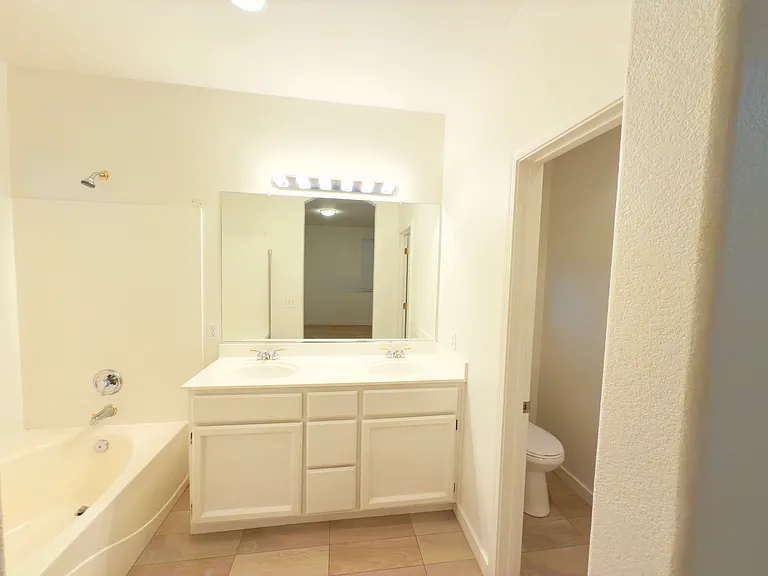Luxurious master bathroom with dual sinks, a soaking tub, and ample space for relaxation and comfort!