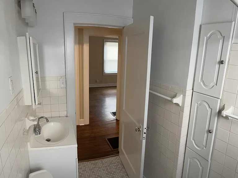 First floor bathroom, view 2 - storage cubbies for towels and toiletries