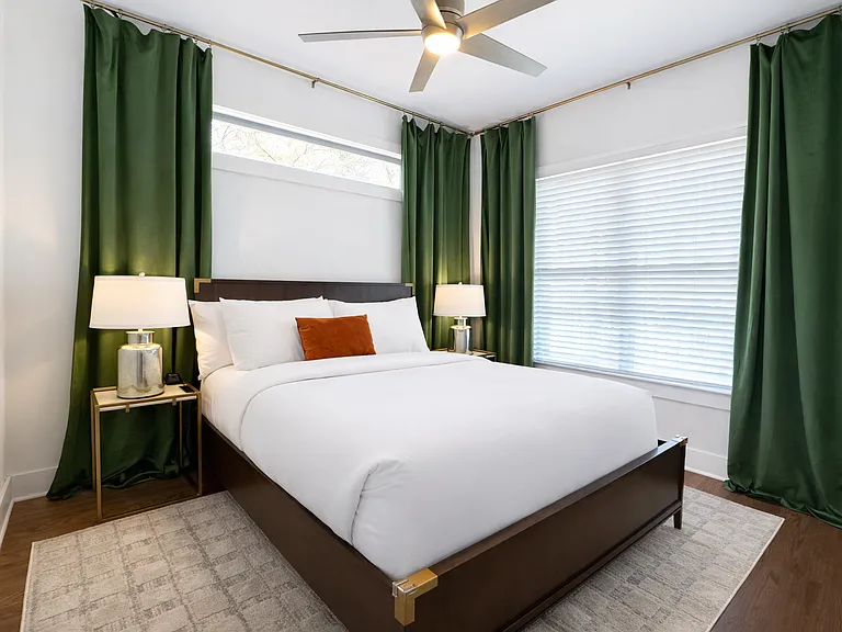 Located on the main floor, the Krog Suite is a relaxing queen room with hotel-level comfort. Enjoy plush linens, Smart TV, ceiling fan, bedside tables with charging ports, dresser, blackout curtains, and stylish designer decor.