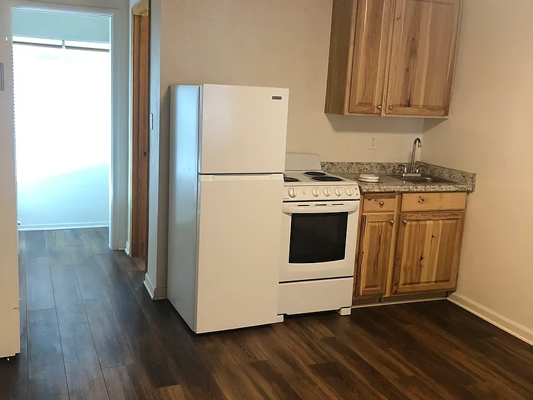 Fresh cabinetry, new refrig and stove! Hallway leads to bathroom
