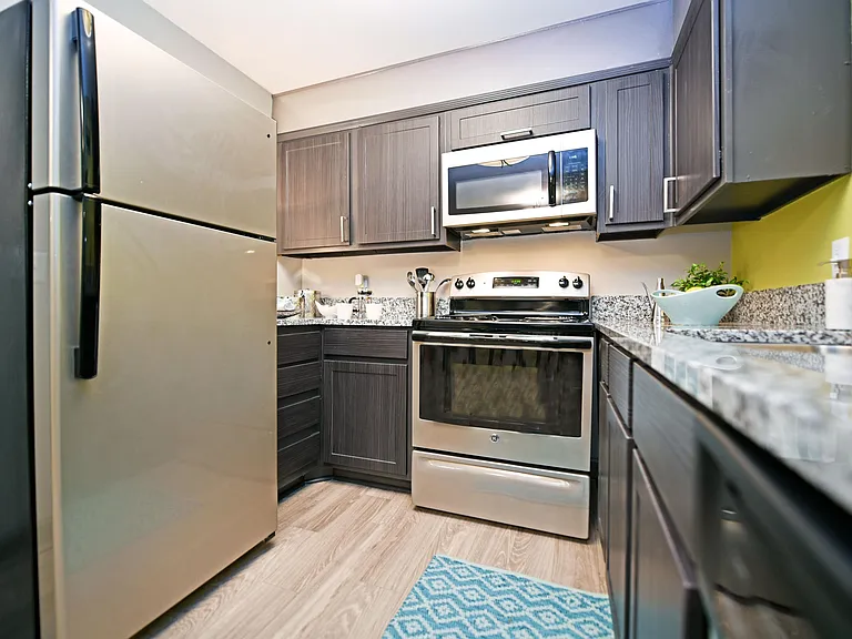 Kitchen with granite counters, stainless appliances, and modern cabinetry