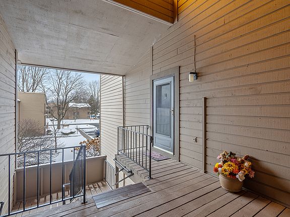 Ascending to the top level, we see the benefits of the covered common space stairwells and porches as you approach the front door. Many residents will decorate their entryway with a pop of color, or small furniture, with electric service featured here as