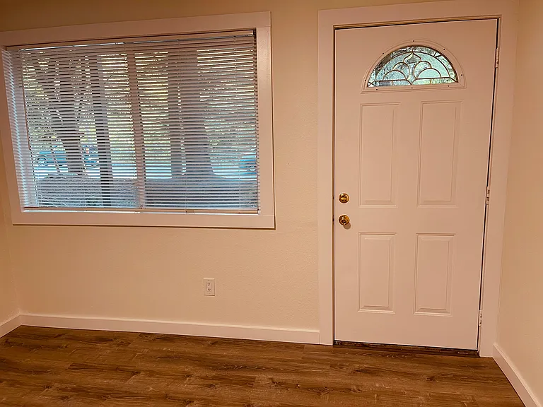 Entryway into the residence. Window looks out to trees and plantings.