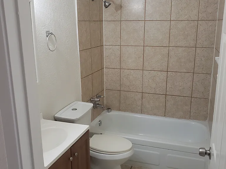 remodeled bathroom with a tile surround