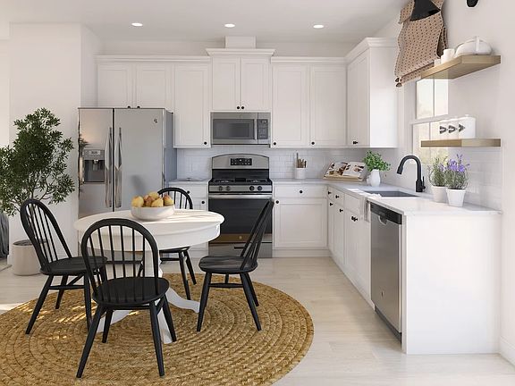 Kitchen with white cabinetry and floating shelves