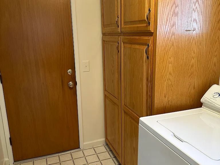 Generous storage in the inside well light Laundry Room. Washer/Dryer included off the half bath and door to two-car garage.