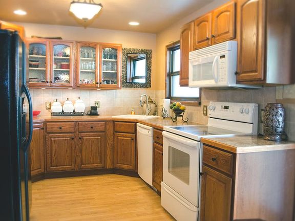Open Kitchen includes, stove, dishwasher, microwave, and Ref
