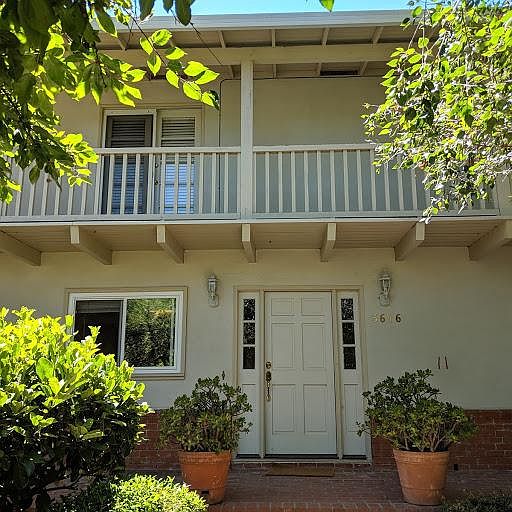 Front of house, with upstairs balcony and French doors to Master bedroom