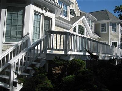 Steps from house-length deck that go down to back yard.