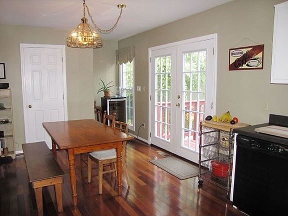 Brazilian cherry wood floors and door to half bath in kitchen.