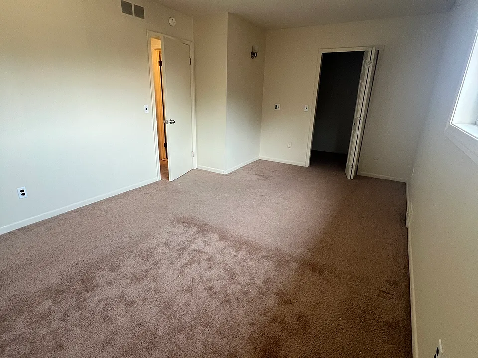 Primary bedroom with view of walk in closet.