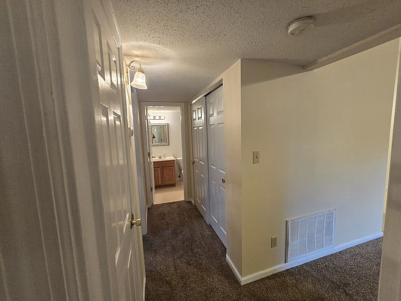 Hallway to bedrooms. Note: utility closet contains personal washer/dryer for convenience.