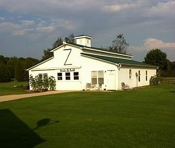 shop, tack room, 3 stalls, + 1bed apy : sliding doors front and back, full length loft, concrete flo