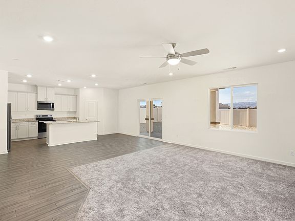 The family room is spacious with a ceiling fan.