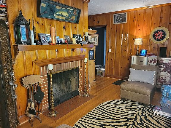 Den with wood burning fireplace