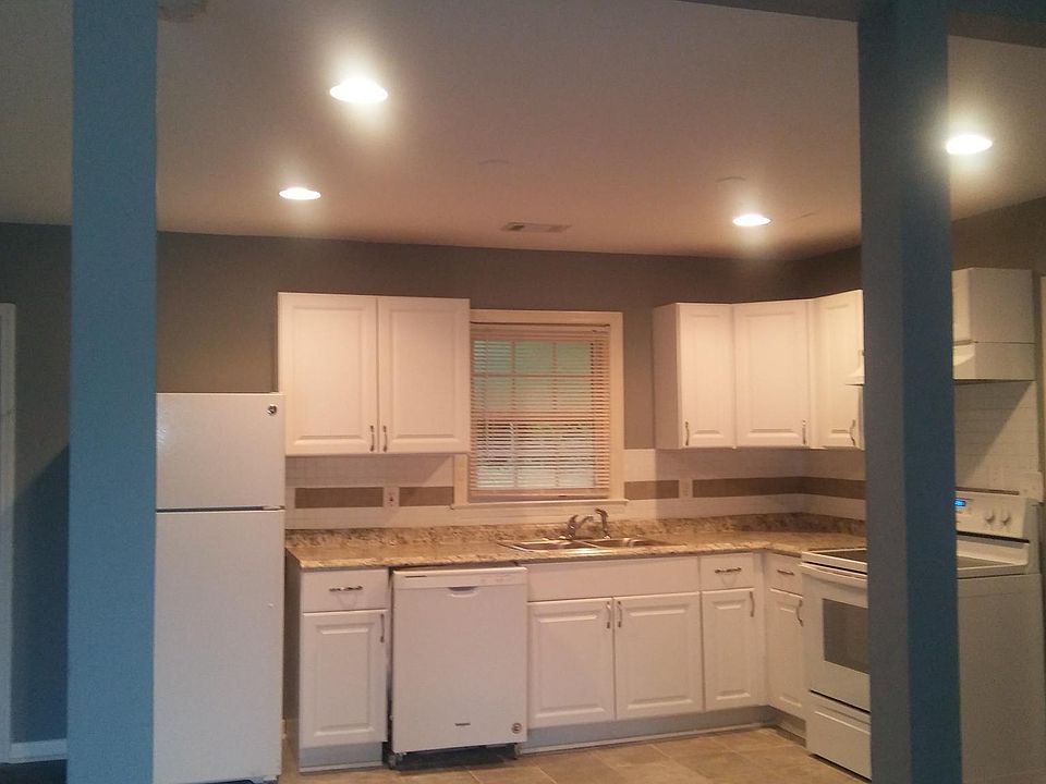Kitchen - New; To the left is French doors that lead to backyard; To the right is the den, half bath, washer/dryer