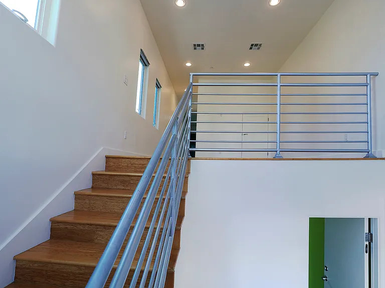 Staircase to Living Room & Passage Door to Garage