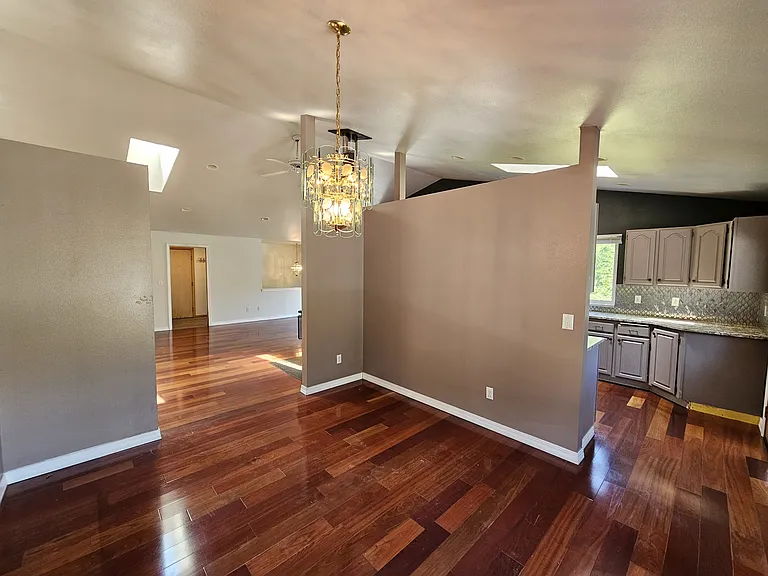 Formal dining room with chandelier perfectly located off of the kitchen and living room