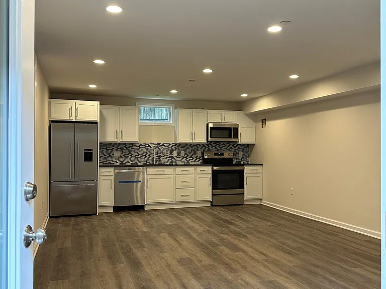 View of common area and kitchen from entry door