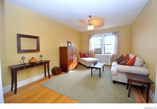 Large sunny living room overlooking the manicured courtyard.