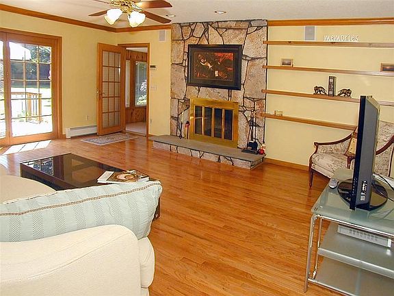 Large Family Room with stone fireplace and built-ins