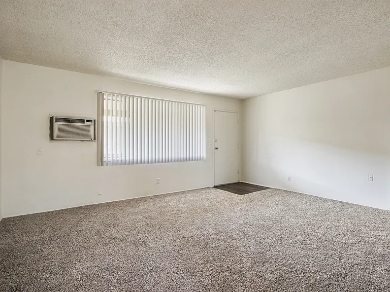 Living room with carpeted floors, air conditioning