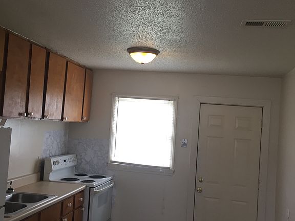 spacious kitchen with refrigerator and oven