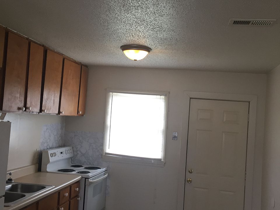 spacious kitchen with refrigerator and oven